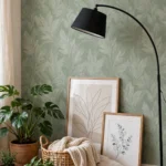 Sage accent wall with leaning framed art, arc floor lamp and plants